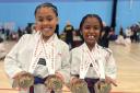 Sisters Ariella and Alyse Dixon-Bellot with their medals. Picture: DUNMOW TKD