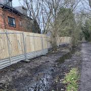 The uprooted path and new fences at Flitch View