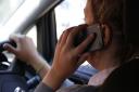 Stricter rules on using a mobile phone while driving have been launched.