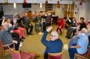 Dunmow and District Stroke Support Group give a wave at their December meeting.