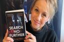 Author AJ Campbell with her third book called Search No Further