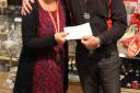 Cllr Keith Artus presents cheques to Fiona Barker, manager of the British Heart Foundation shop in Saffron Walden