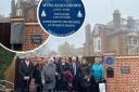 Plaque unveiled: family members gathered the see the new plaque