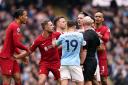The IFAB is set to commission trials to stop players surrounding referees (Mike Egerton/PA)