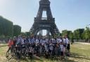 Fundraising cyclists for Kids Inspire arrive at the finish life of the Eiffel Tower, Paris