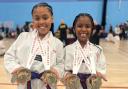 Sisters Ariella and Alyse Dixon-Bellot with their medals. Picture: DUNMOW TKD