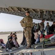 British citizens and dual nationals residing in Afghanistan boarding an RAF plane before being relocated to the UK