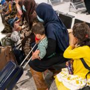 Refugees from Afghanistan wait to be processed after arriving on an evacuation flight at Heathrow Airport.