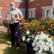 Peter Birsan, maintenance manager at Mountfitchet House, with his Stansted in Bloom awards