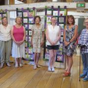 The unveiling of the Quilt Banners in Great Dunmow. Participants with textiles artist Ellen Jackson 5th from left and Pat and Steve Schorah (right)