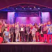 The cast of Saffron Walden Musical Theatre Company's production of Kinky Boots back in March, when SWMTC members were presented with their centenary certificate from NODA.