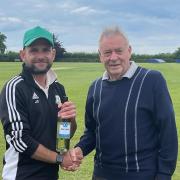 Stock`s Dave Cole receiving the Aythorpe Roding president's man of the match award from Brian Hockley.