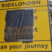 A RideLondon sign in Great Dunmow, covered with a bin liner, as the information is wrong
