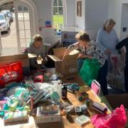 People helping Saffron Walden resident Kateryna Shotropa pack donated items which have been boxed up and driven to the Ukraine border
