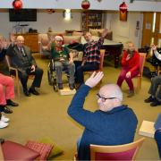 Dunmow and District Stroke Support Group give a wave at their December meeting.