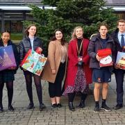 Felsted School students with Miss Sunshine and Miss McCaughern and some of the parcels they have created to bring cheer to others