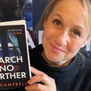 Author AJ Campbell with her third book called Search No Further