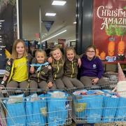 Amy, 9, Erika, 8, Emily, 8, Bella, 8, and Maddie, 9, shopping on behalf of the 1st Thaxted Brownie Unit for Uttlesford Foodbank