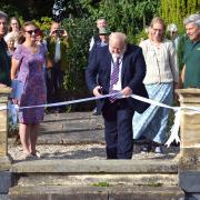 Councillor Martin Foley of Uttlesford District Council and Essex County Council cuts the ribbon at the Gardens of Easton Lodge, Little Easton, to mark the completion of the restoration project in Little Easton