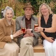 Stane House homeowners enjoy a drink at their summer party